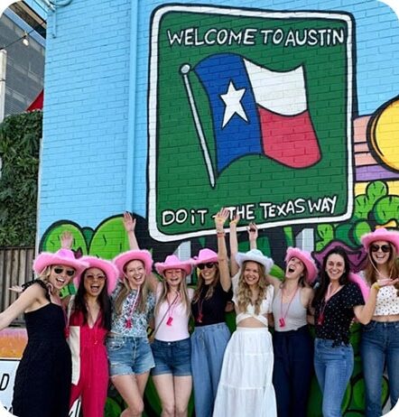 bach party in front of texas mural