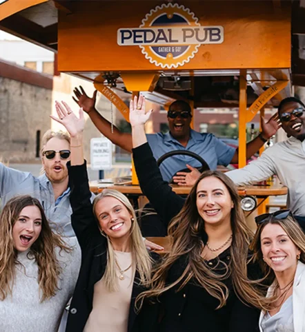 coworkers posing in front of party bike