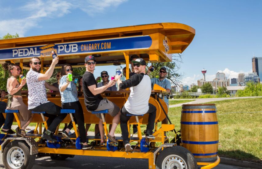 close-up of friends smiling on pedal pub bike