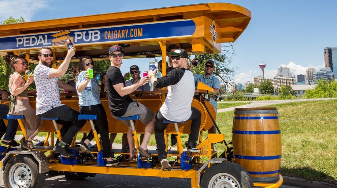 close-up of friends smiling on pedal pub bike