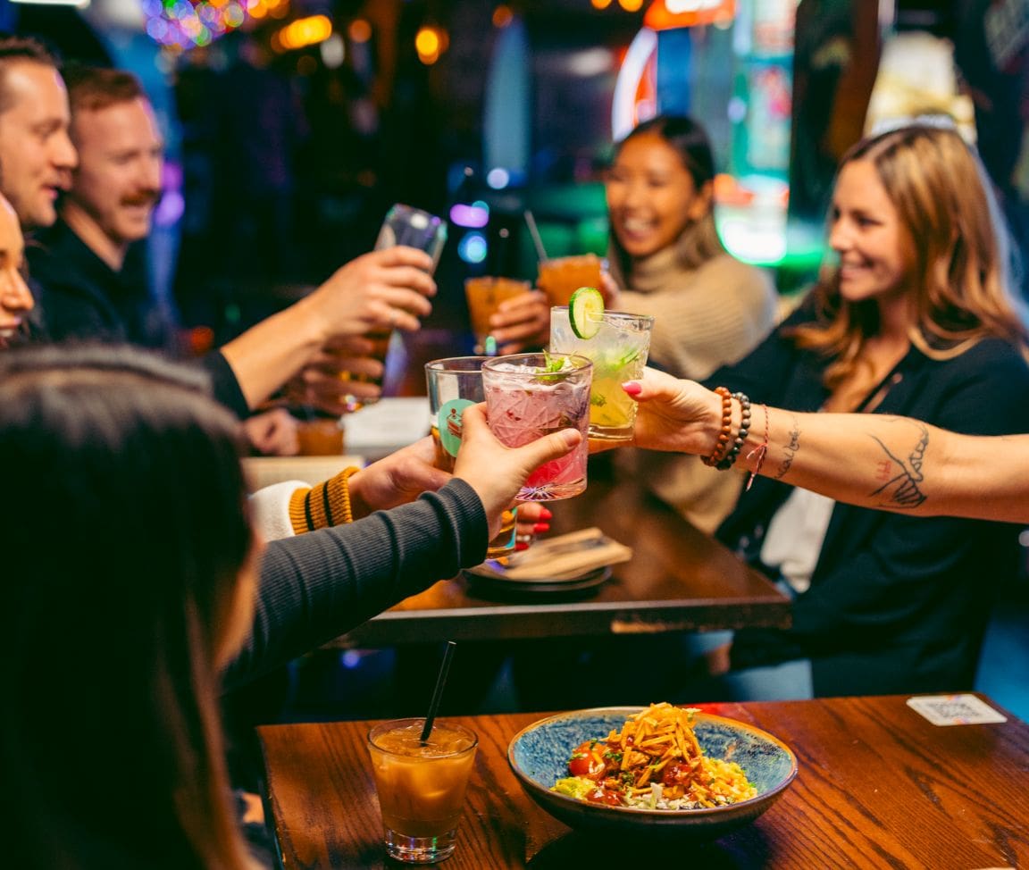 friends cheersing drinks at Greta Bar