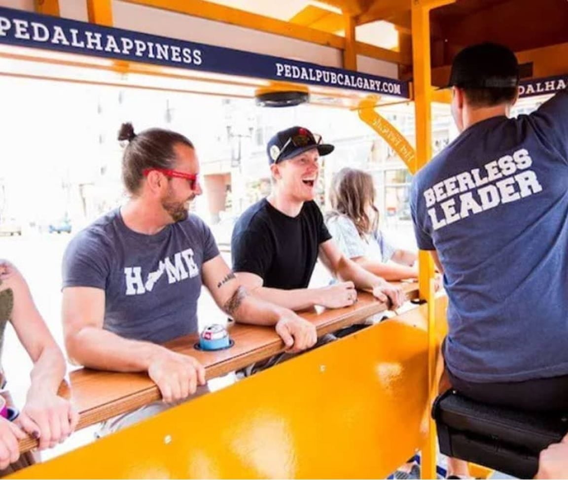 men pedaling on party bike in calgary