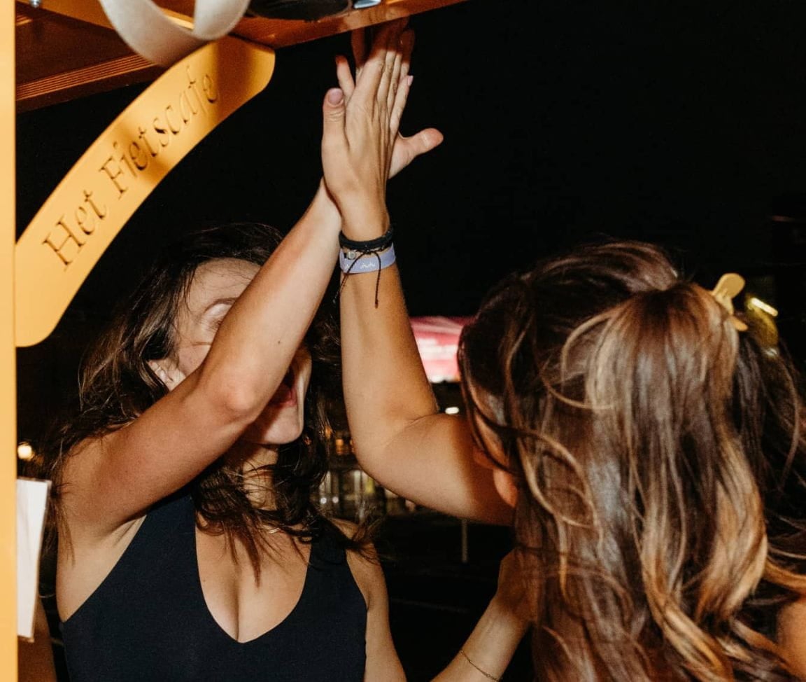 women high-fiving each other