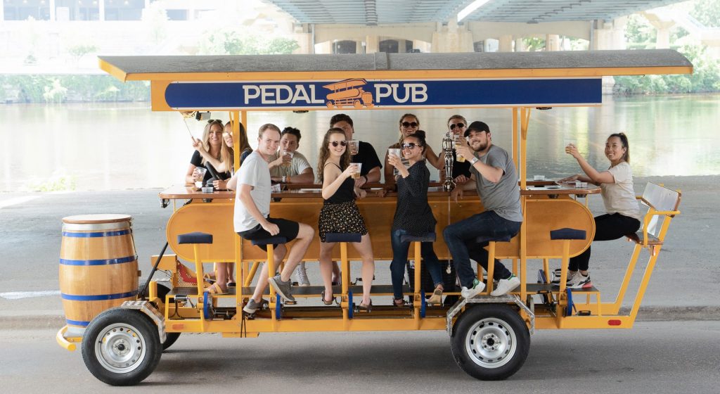 friends riding pedal pub