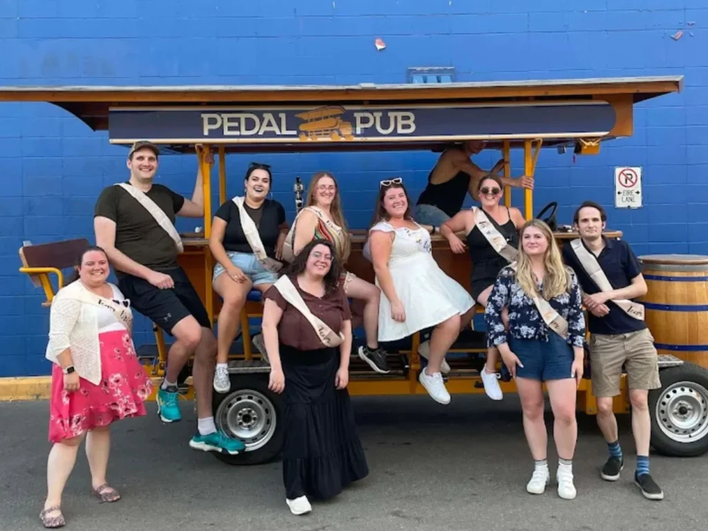 bachelorette party guests posing with party bike