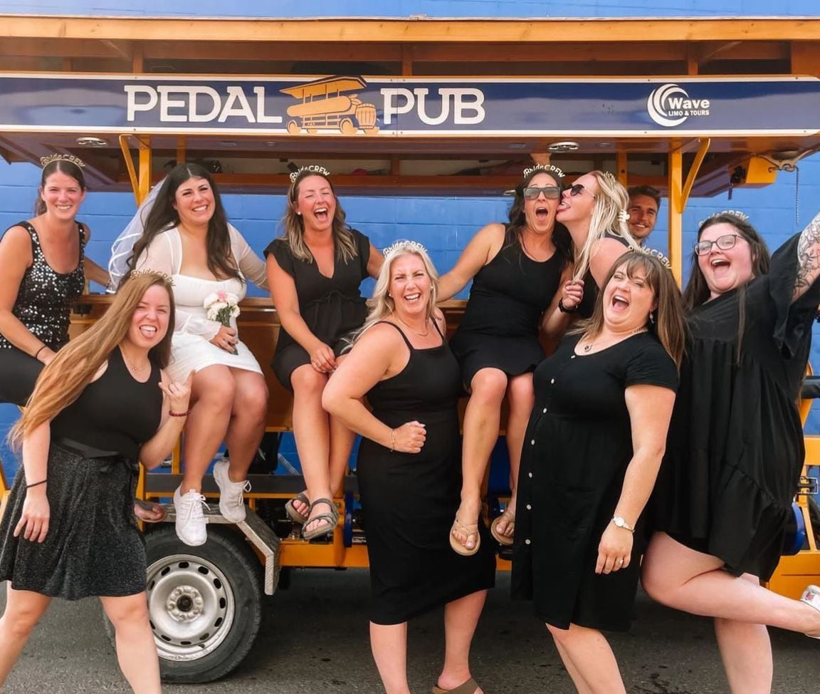 bachelorette party guests posing with Pedal Pub