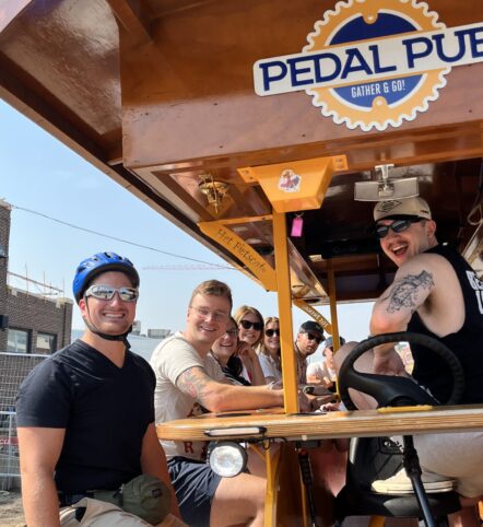 friends sitting on party bike