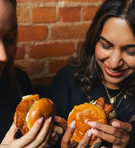women eating sandwiches