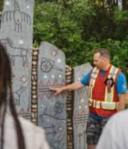 Instructor teaching about illustrations on a rock