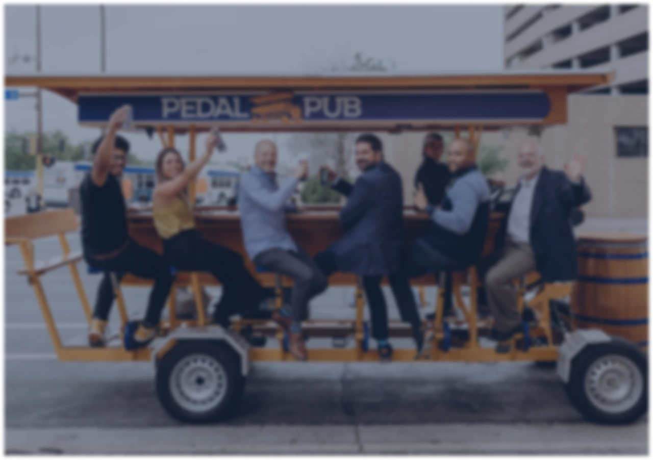 Corporate group riding a Pedal Pub through the city