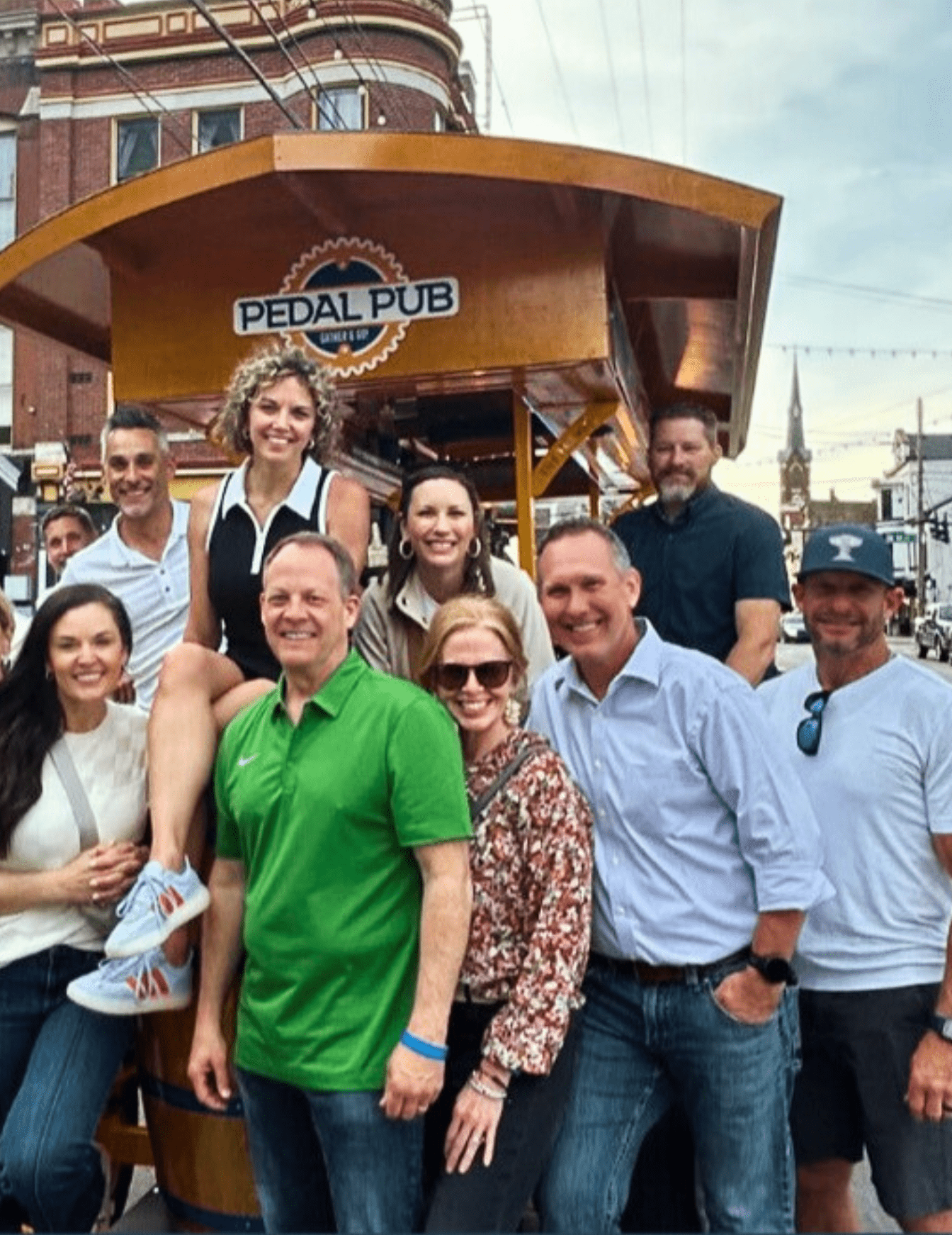 company outing posed in front of party bike