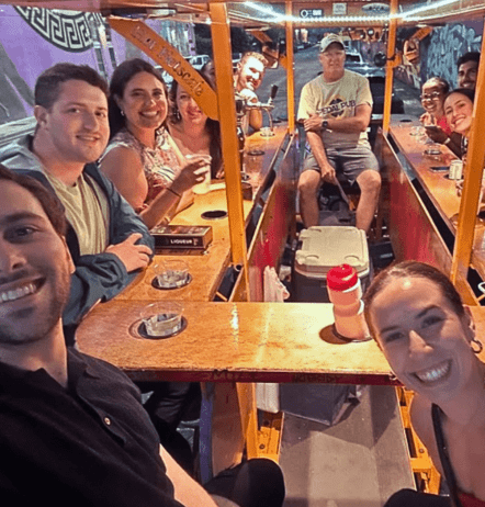Company outing group sitting inside party bike