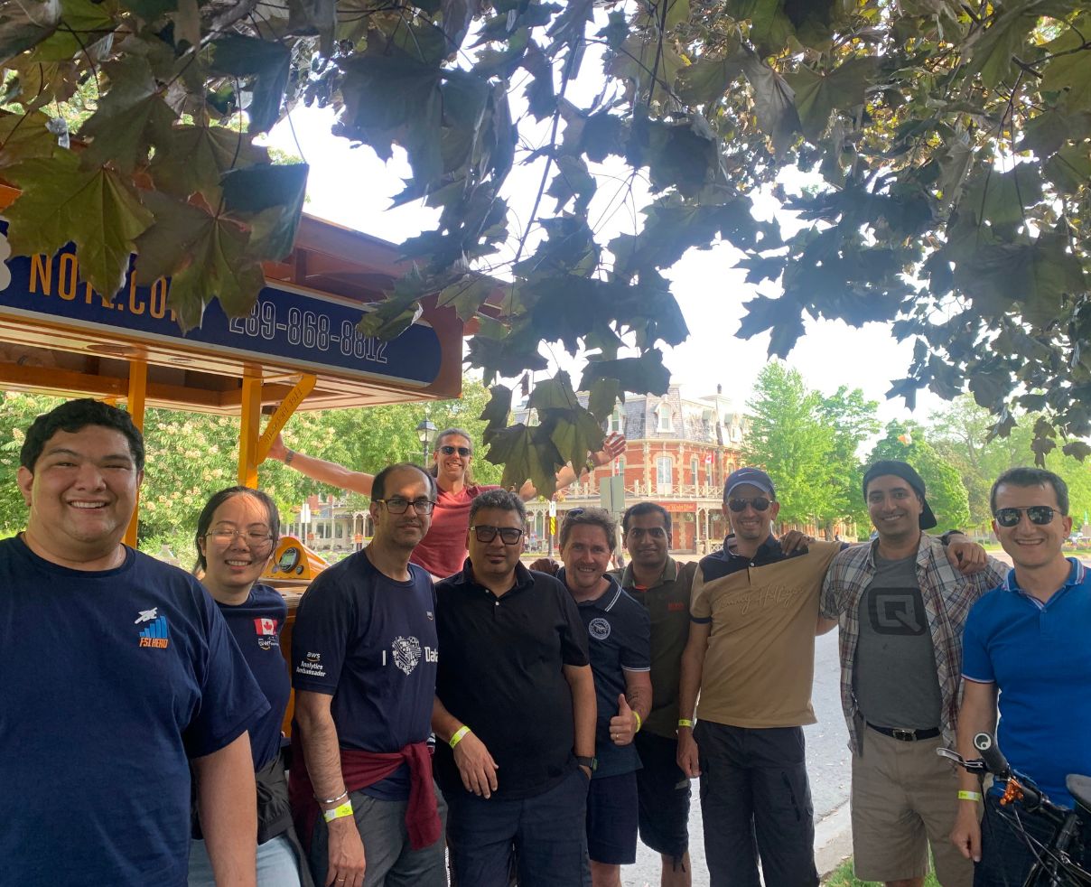 employees in front of Pedal Pub for company outing