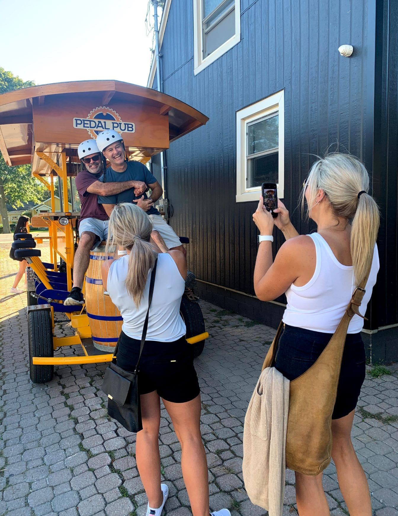 friends taking photos on party bike