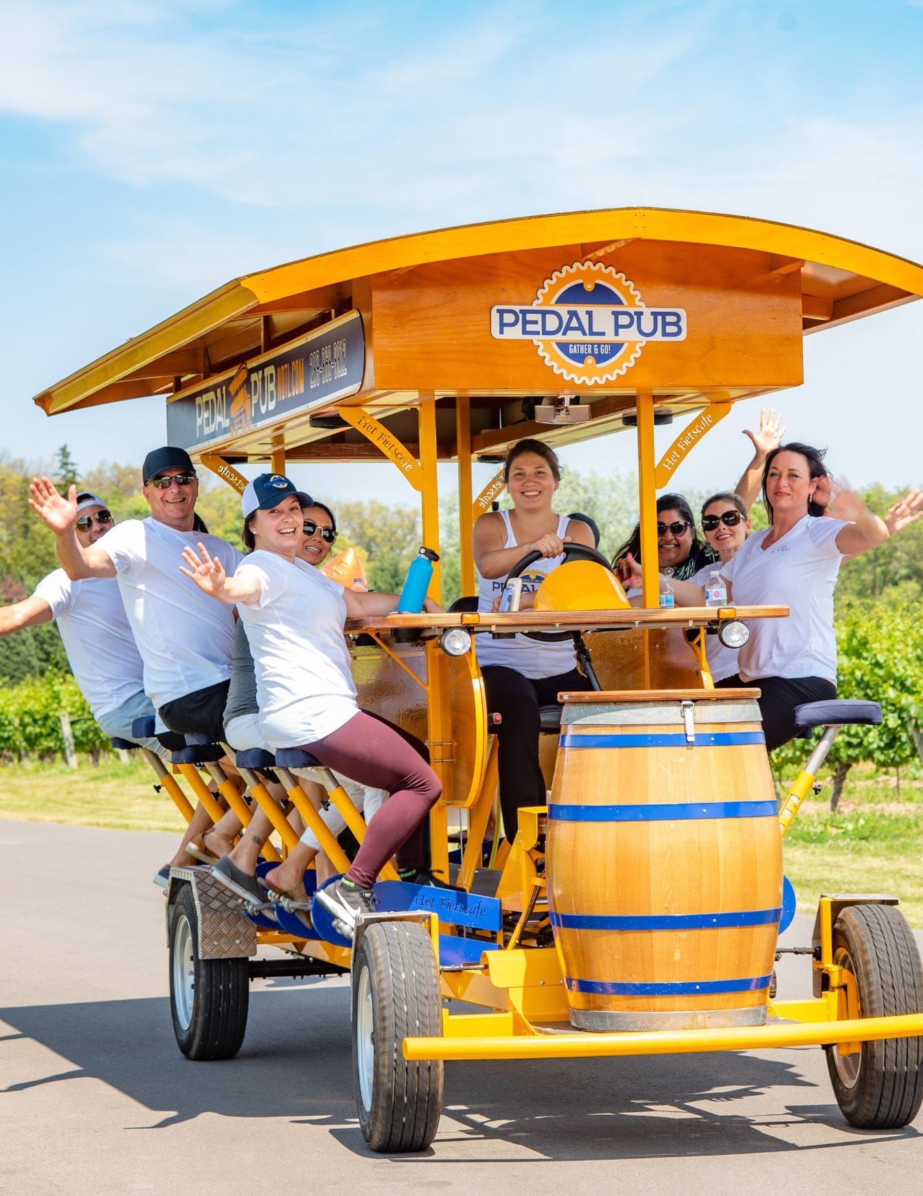 friends waving while pedaling on party bike