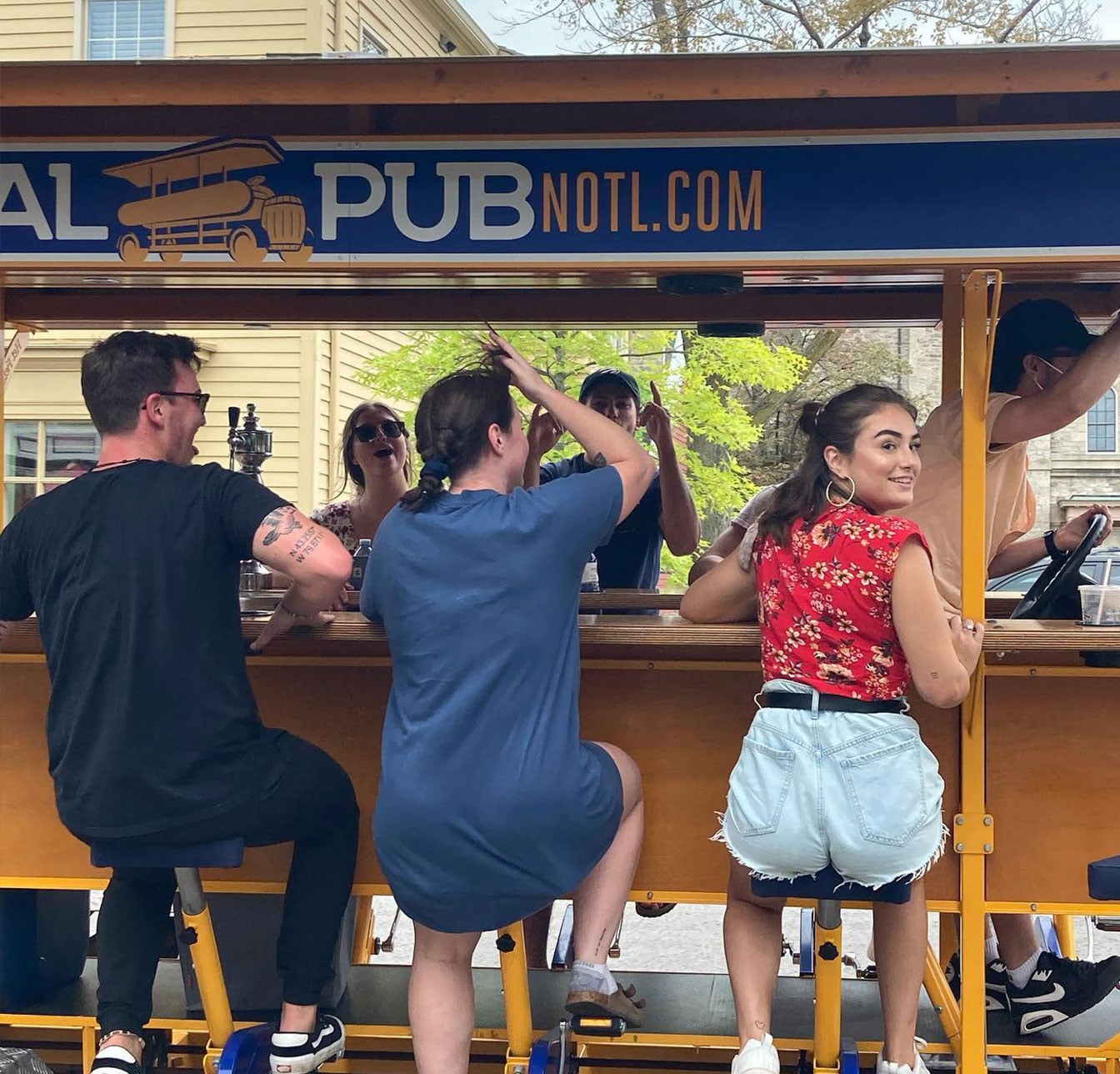 guests riding Pedal Pub NOTL