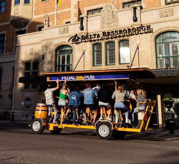 group of people on pedal pub bike on road
