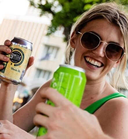 close-up of women smiling with drink in her hand