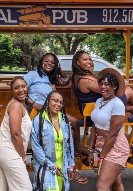 group of woman in front of party bike in savannah