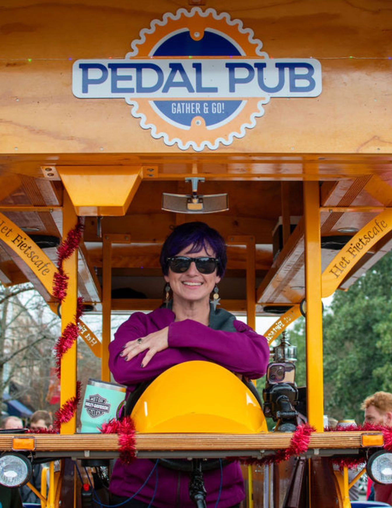 woman sitting in drivers seat on pedal pub bike