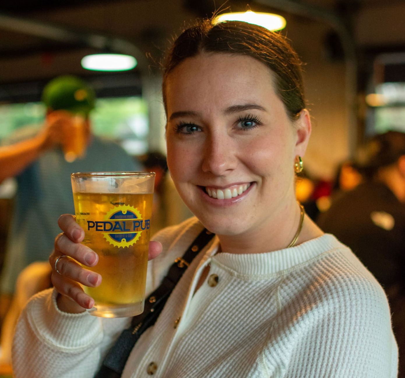 close-up of woman smiling while holding beer