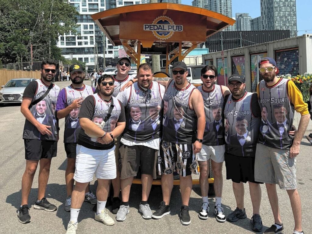 bachelor party in front of Pedal Pub bike