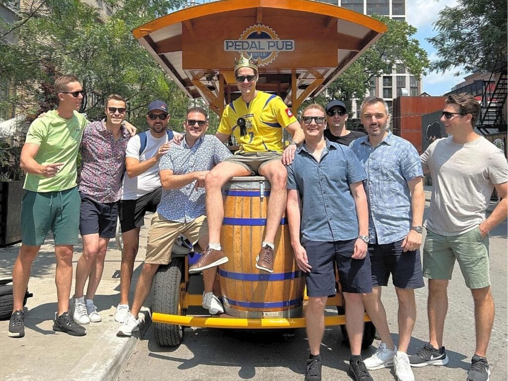 men standing in front of Toronto party bike