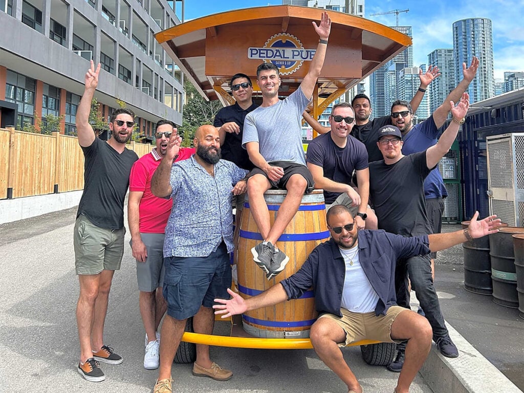 a bachelor and his friends gathered around a party bike