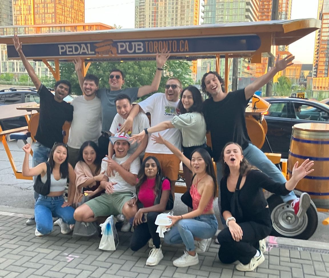 friends posing in front of party bike