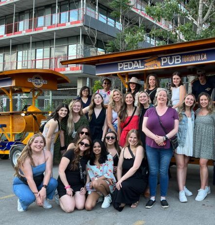 employees in front of party bike before company outing tour