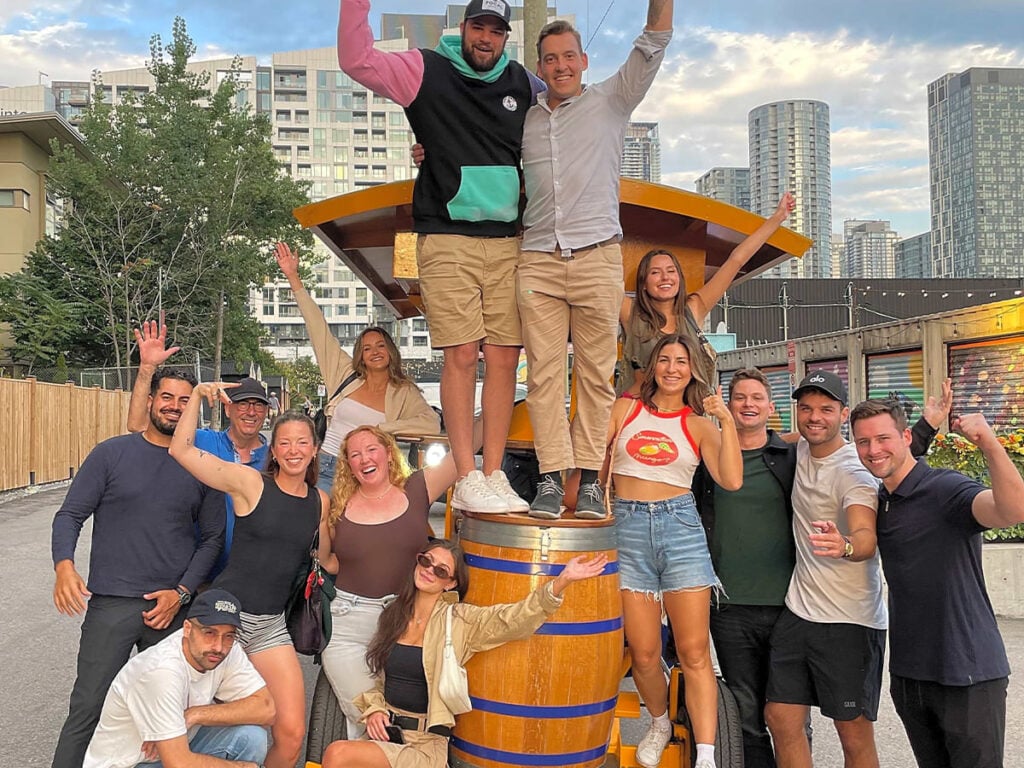 a group of friends posing for a photo by a party bike