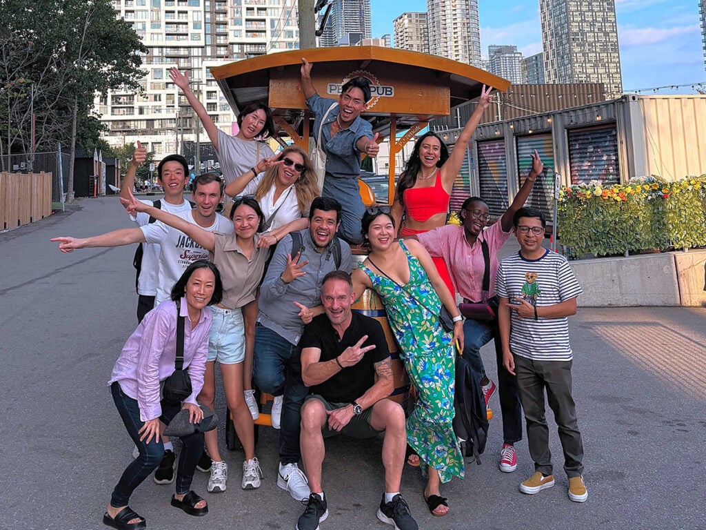 friends happily posing by a party bike