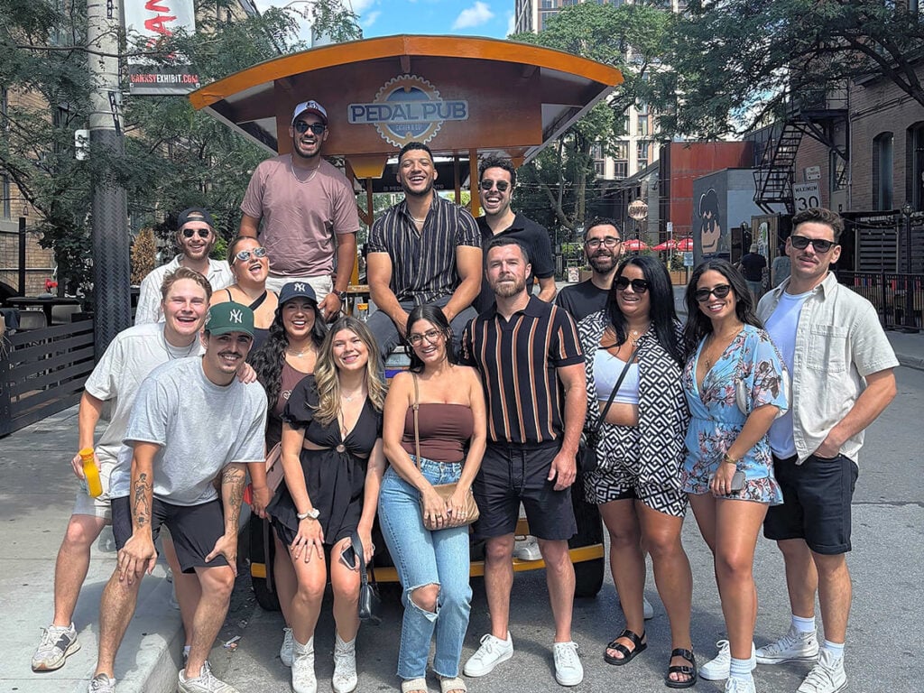 group of people in front of Pedal Pub Toronto party bike