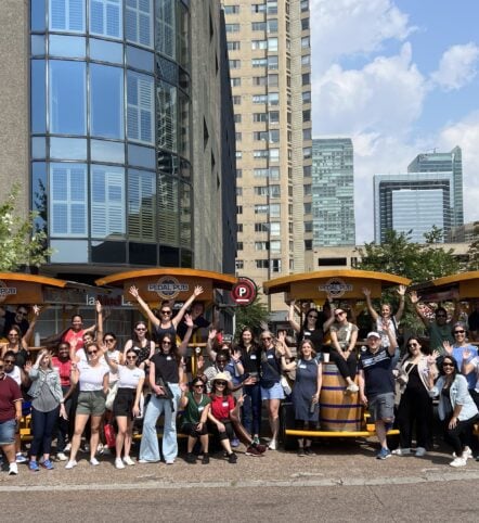 team posing with Pedal Pub bikes