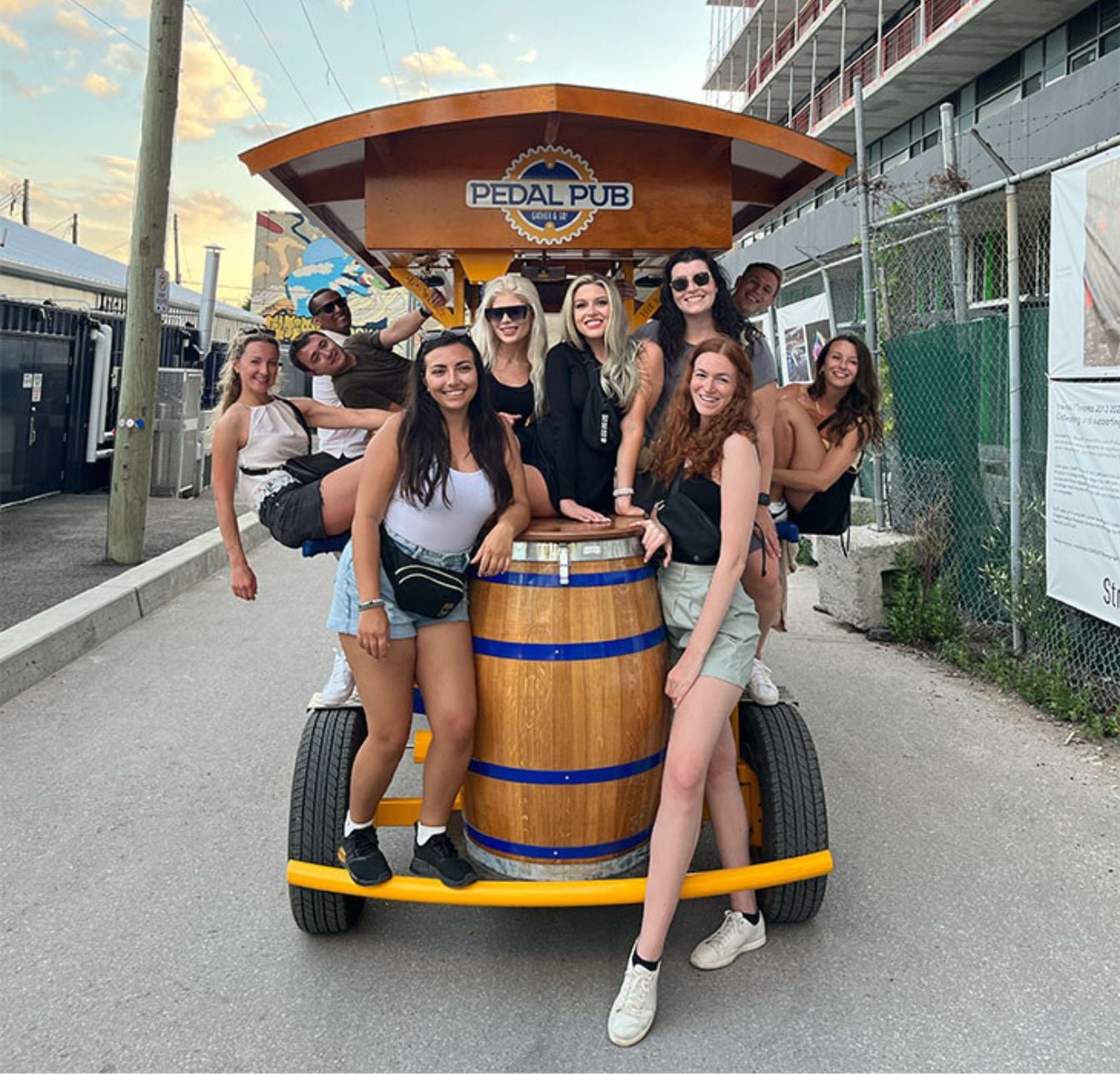 Pedal Pub Toronto riders seated and standing around bike