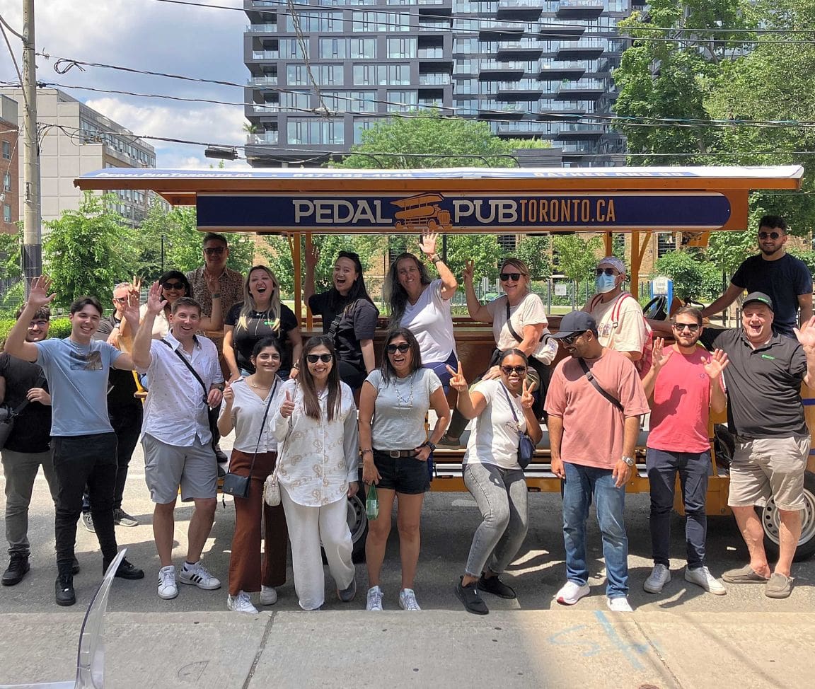 group of employees from Toronto company in front of Pedal Pub bikes