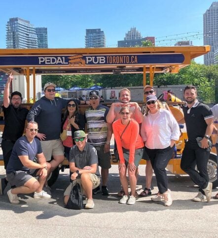 company outing in front of a Pedal Pub