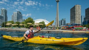 guy kayaking with Toronto skyline view