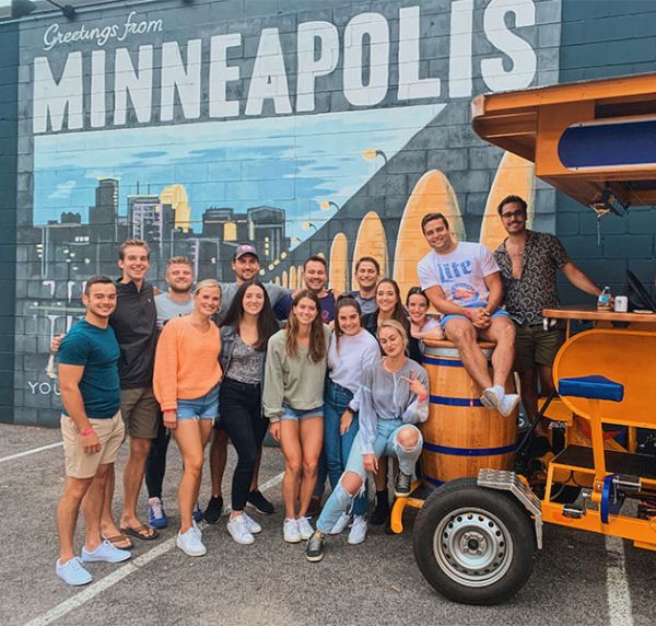 Pedal Pub riders in front of Minneapolis mural