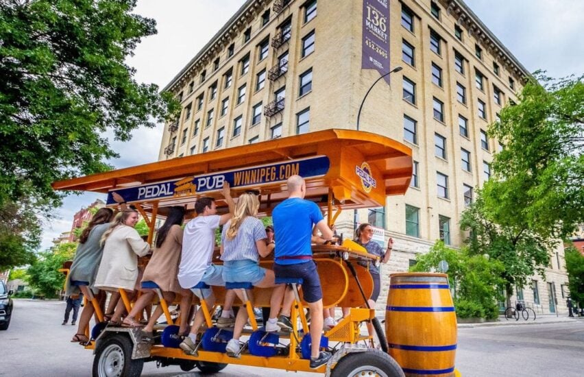 group of friends riding pedal pub bike in winnipeg