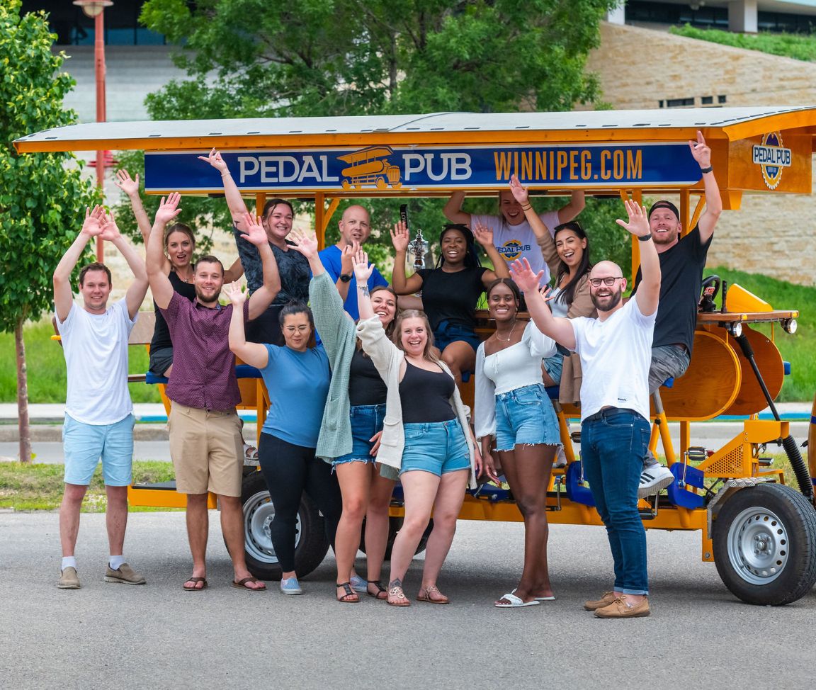 friends posing with Winnipeg party bike