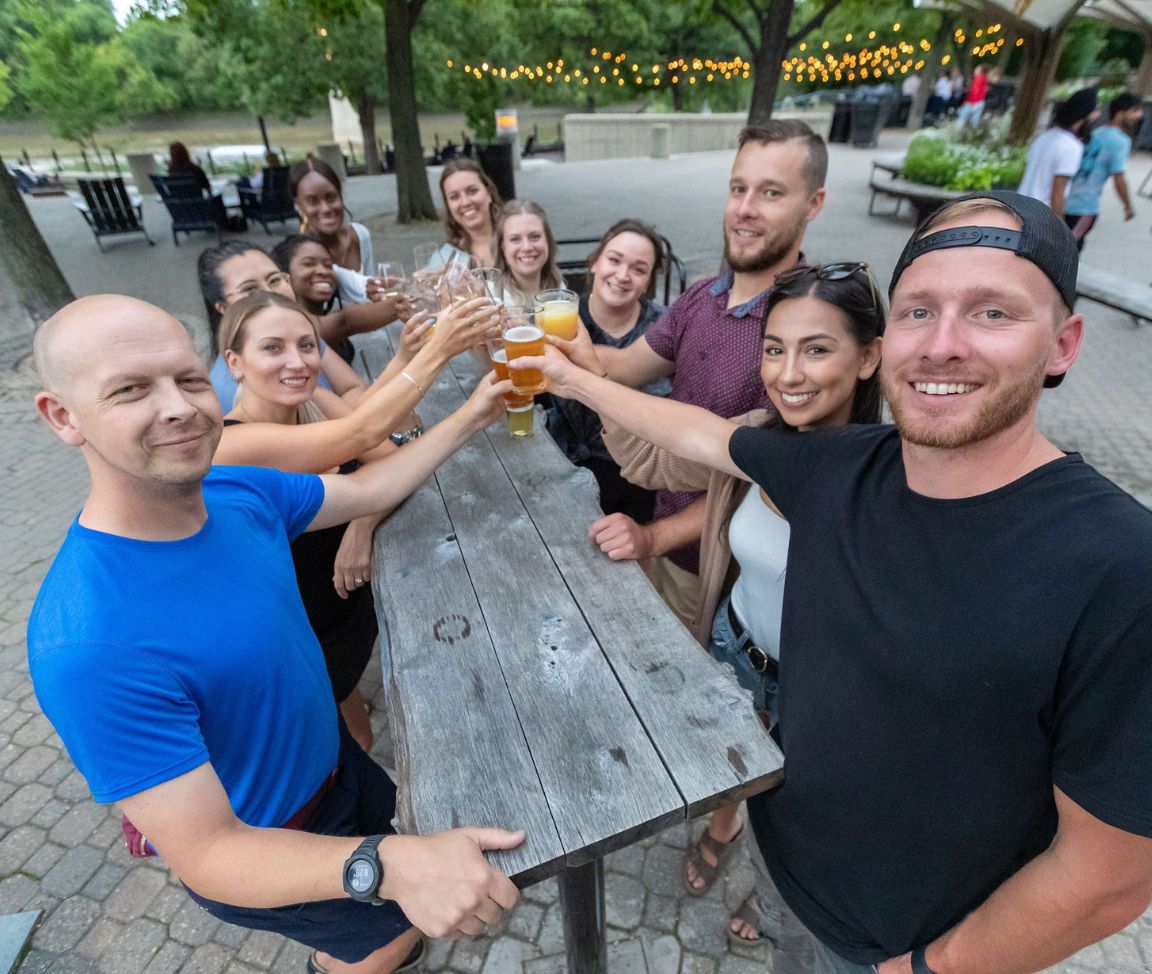 friends cheersing drinks at bar in Winnipeg