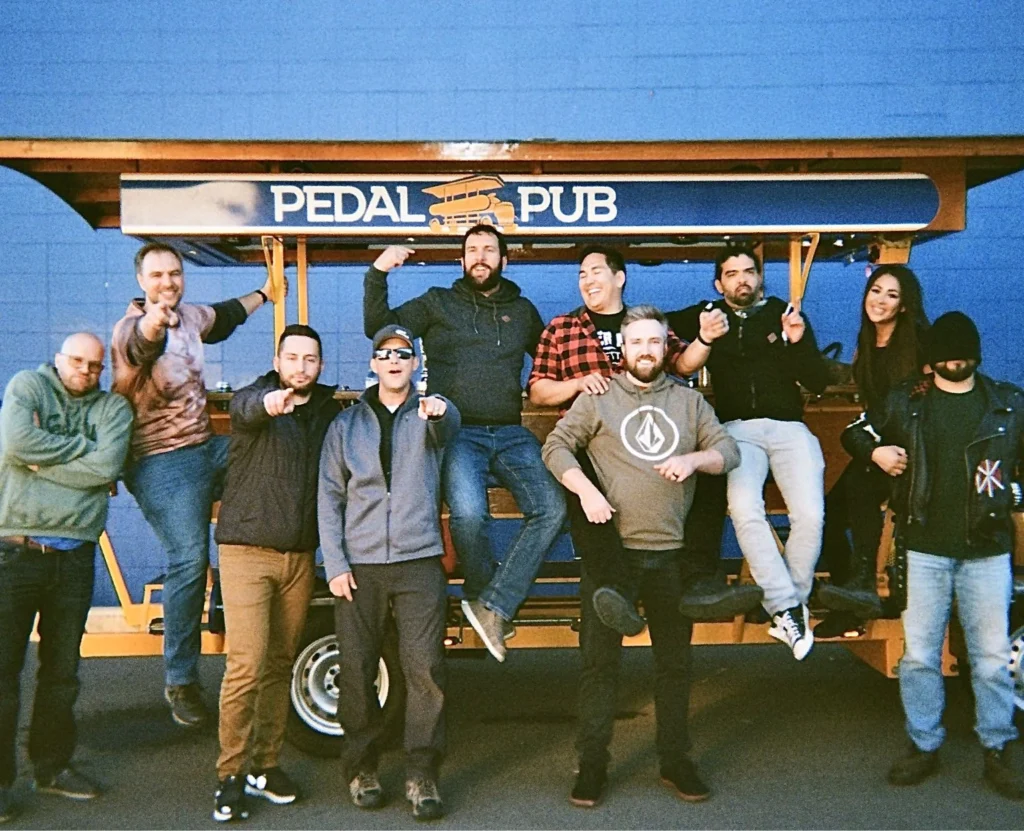 bachelor party posing with Pedal Pub
