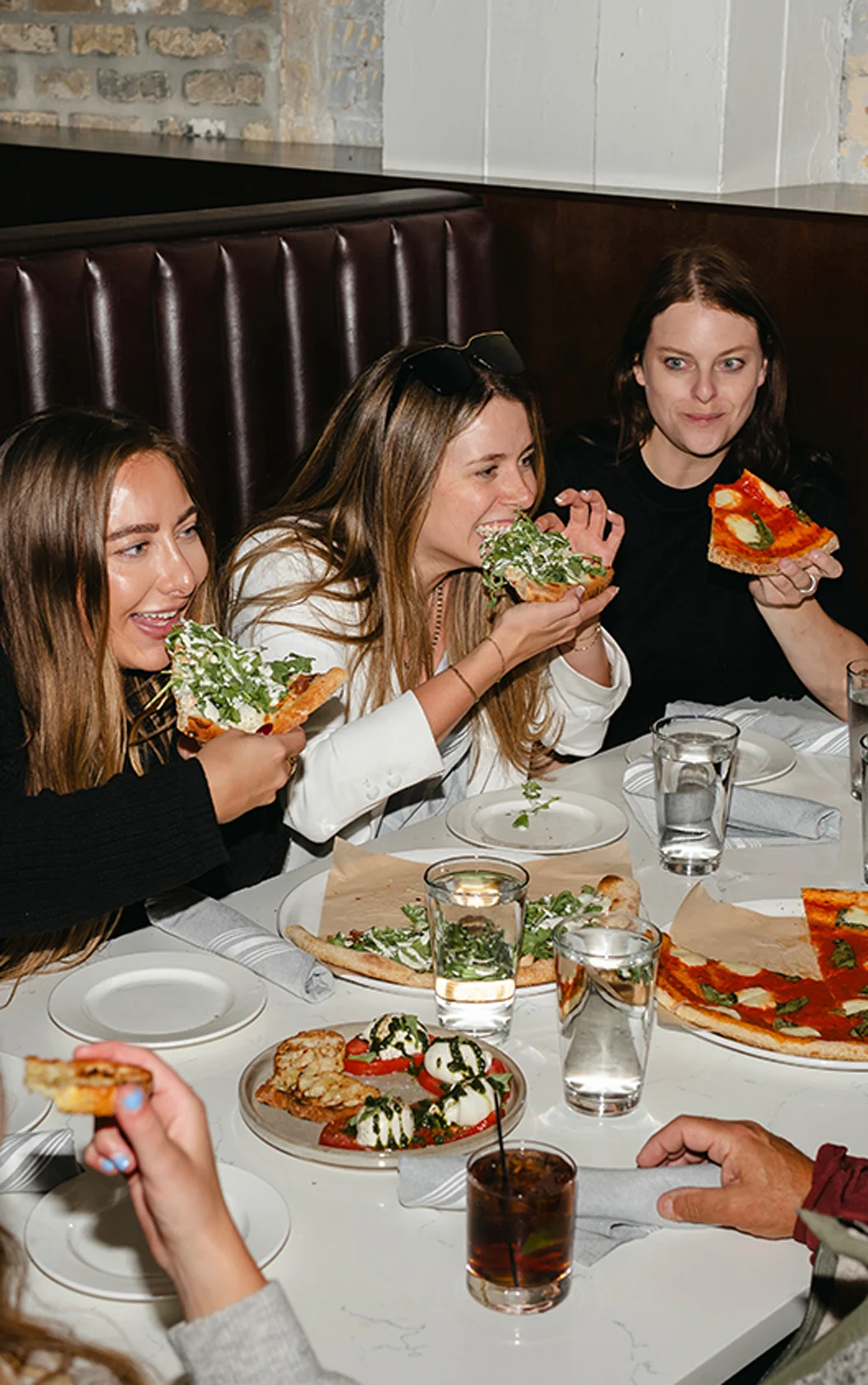 employees on company outing eating pizza together