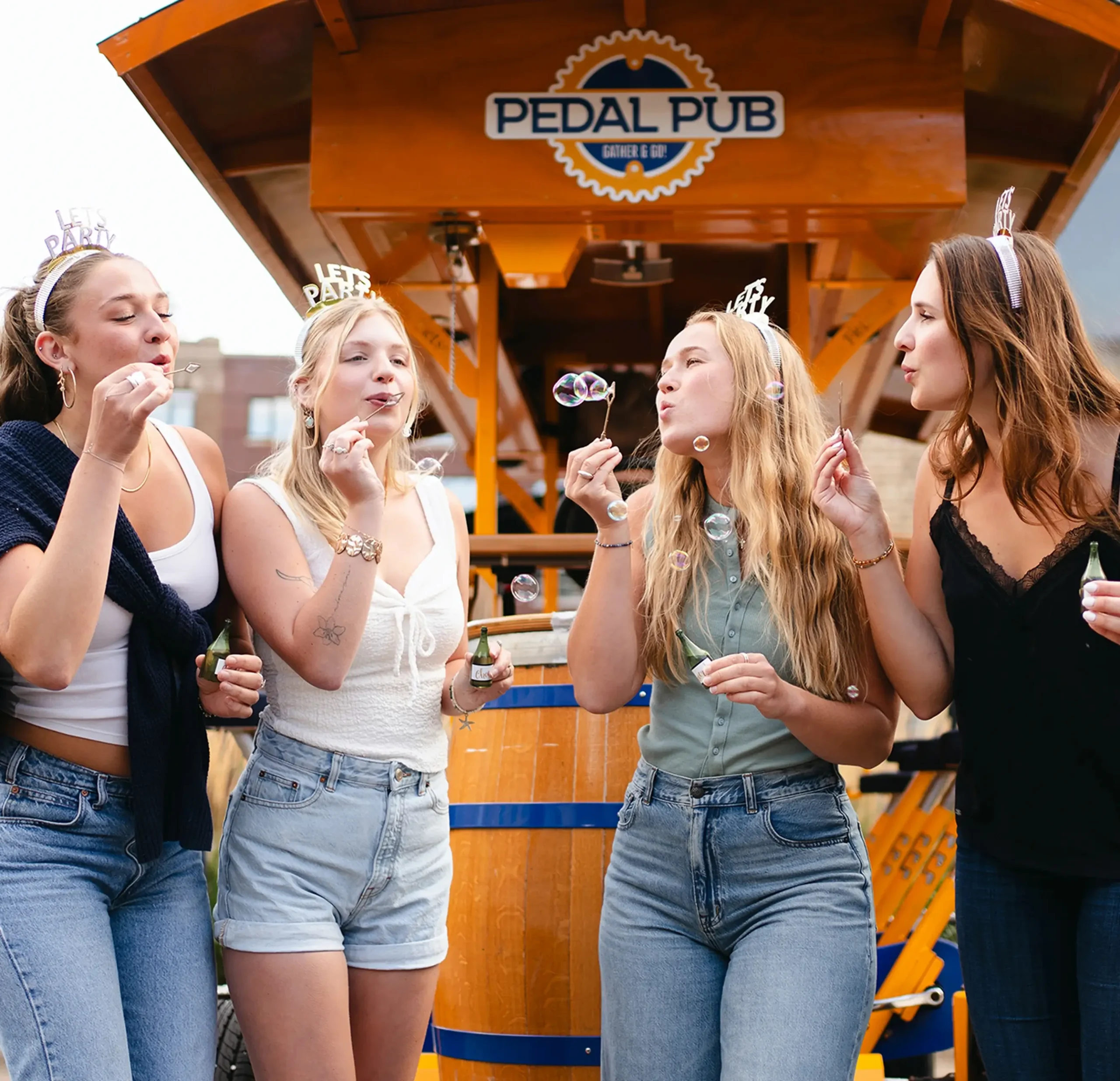 friends blowing bubbles on Pedal Pub for a birthday party